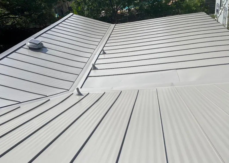 Solar attic fan installed on a metal roof for Roof Ventilation in Thief River Falls